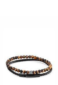 Perlearmbånd med brune og svarte tigereye-stener, en flettet svart lær-snor og en sølvspenne med et løveemblem.