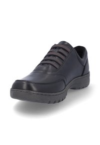 Zapato de cuero negro con suela de goma, punta redondeada y detalles de costura. Presenta cordones oscuros y un cuello acolchado para mayor comodidad.