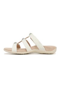 White slide sandals with three narrow straps, textured surface, cushioned footbed, and a durable beige outsole with grip patterns.