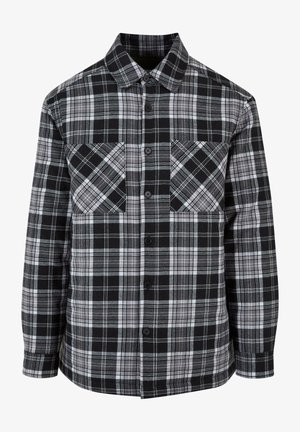 Must ja valge ruuduline särk, millel on nupuga esiosa, kaks rinna-taskut ja pikad varrukad, millel on mansetid. Valmistatud kergest kangast.