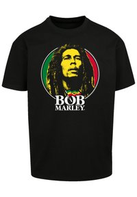 Black cotton t-shirt featuring a circular graphic with Bob Marley’s face, accented in yellow, red, and green. Text reads "BOB MARLEY."