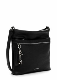 Black leather shoulder bag with adjustable strap, front zip pocket, and silver letter charm detail. Soft texture with minimalistic design.