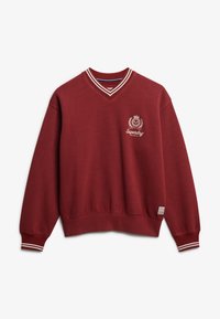 Sudadera burdeos con escote en V, cuello y puños acanalados. Presenta un logo bordado en blanco en el pecho y acentos de rayas en las mangas.