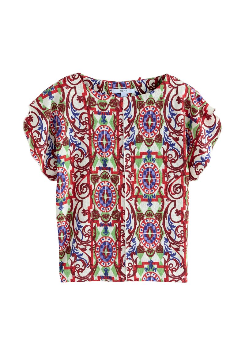 Haut à manches courtes en tissu texturé avec un motif floral coloré et orné en rouge, bleu, vert et blanc.