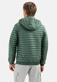 Green puffer jacket with horizontal quilted texture, hood, and elastic cuffs. Made of lightweight, shiny material. Warm, casual design.