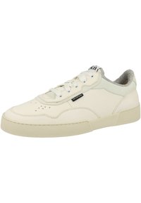 White leather sneaker with perforated accents, grey suede detailing on the collar, flat laces, and a light-colored rubber sole.