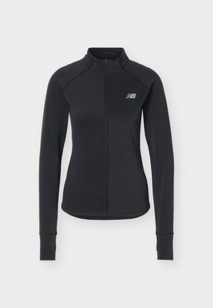 Veste de sport noire à manches longues avec fermeture éclair à l'avant et petit logo blanc New Balance sur la poitrine gauche.