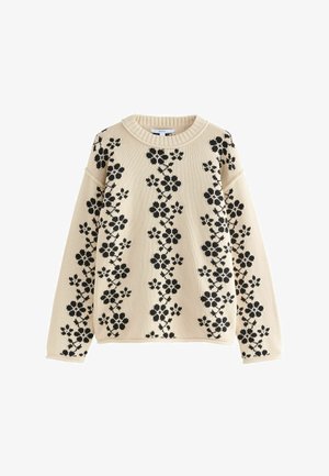 Krémový svetr se černým květinovým vzorem, žebrovaným kulatým výstřihem, uvolněným střihem a spadlými rameny. Pletená textilie s dlouhými rukávy.