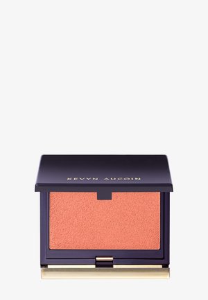 Fard à joues compact avec un étui violet profond et des accents dorés. Contient une poudre pêche texturée à l'intérieur, conçue pour une application facile.