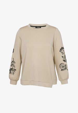 Sweat-shirt beige à manches longues avec encolure ronde et imprimés floraux noirs sur les deux manches, coupe ample avec poignets et ourlet côtelés.
