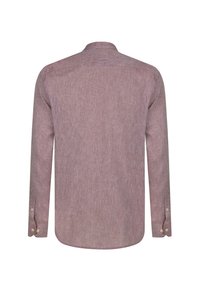 Pikkade varrukatega särk pehmest, mauve värvi kangast, millel on tekstuuriga kudumine. Särgil on nööbid kaeluses ja ümar alläär, nööbid varrukate äärtes.