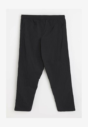 Czarne, lekkie spodnie wykonane z materiału ripstop. Posiadają elastyczny pas i zamykane na zamek kieszenie boczne. Prosty krój nogawek.