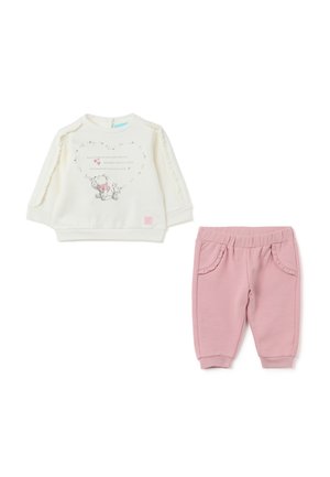 Weißer Pullover mit Rüschenärmeln und einem Grafikdesign mit einem Bären. Rosa Hose mit Rüschendetails an den Taschen. Weicher Stoff. Lässiges Design.