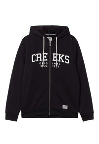 Sudadera con cremallera negra hecha de tejido suave, con capucha forrada de sherpa, bolsillos frontales y texto blanco "CREEKS ORIGINAL Desde 1974".