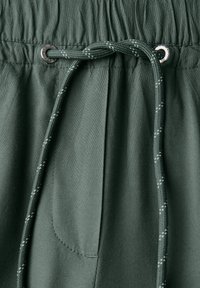 Dark green fabric shorts with an elastic waistband, featuring a decorative drawstring with a silver look toggle and subtle stitching details.