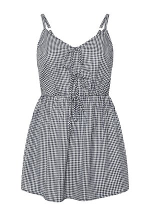 Vestido sin mangas de cuadros vichy en blanco y negro, con tirantes ajustables, detalles de lazo en el frente y cintura fruncida.