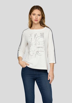 White three-quarter sleeve t-shirt with a round neckline. Features a graphic design in silver and navy stripes along the sleeves.
