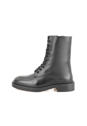 Black leather ankle boot featuring a rounded toe, six eyelet lace-up closure, smooth texture, and a thick black rubber sole.