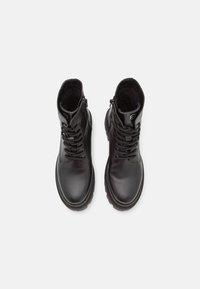 Black leather ankle boots with a smooth finish, round toe, lace-up front, and side zipper, featuring a rubber sole for traction.