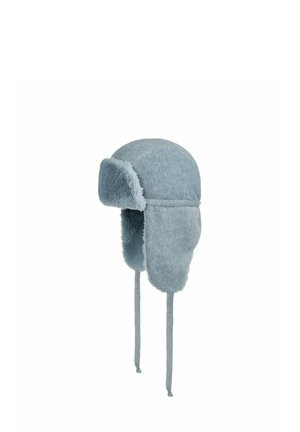 Light blue faux fur trapper hat with ear flaps and long ties hanging down on a white background.
