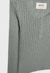 Gray ribbed sweater with long sleeves, featuring a V-neck and five buttons at the front. Made of soft textured knit fabric.