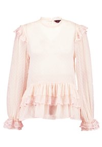 Jasnoróżowa bluzka w kropki. Posiada falbaniaste rękawy i dół, koronkowe detale, wysoki kołnierz oraz zapięcie na guziki z tyłu.