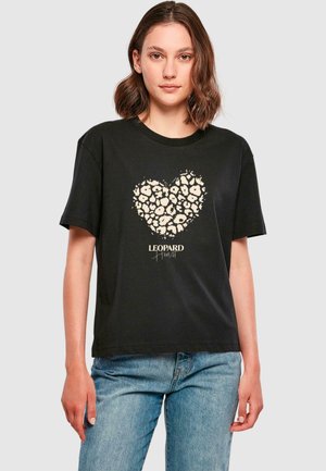 Black cotton t-shirt featuring a leopard print heart design in beige with the text "LEOPARD Heart" below. Short sleeves and crew neck.