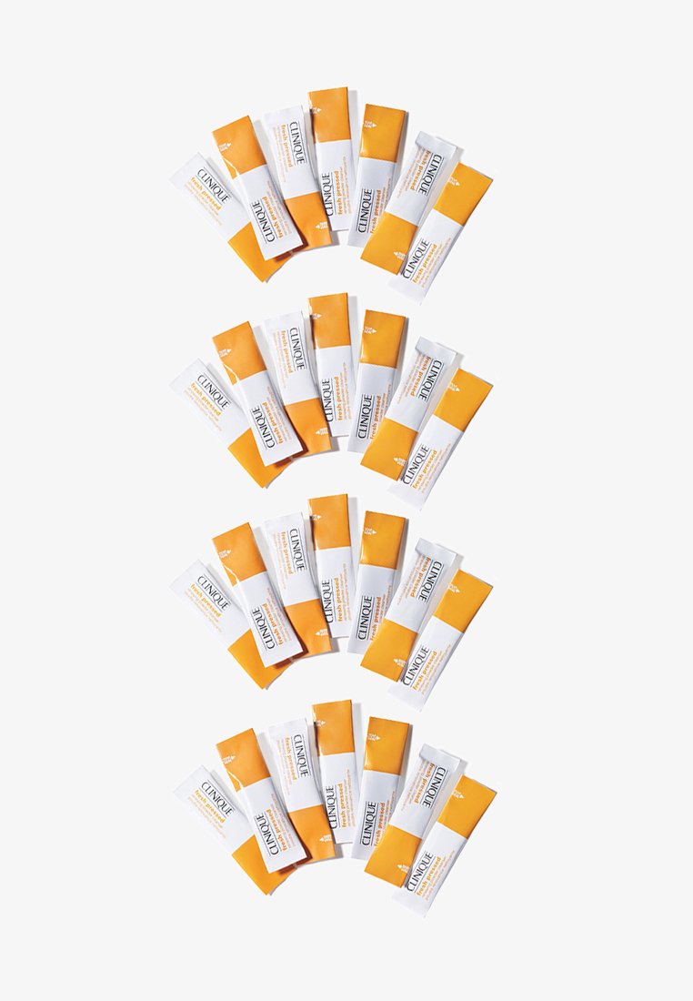 Clinique skincare packets arranged in a fan shape; white and orange packaging with text detailing product name and benefits.