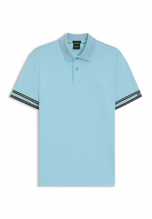 Valkoinen pikeepaita, jossa on kaulus, kolme napinläpeä ja musta-valkoiset raidat hihoissa. Valmistettu sileästä kankaasta.