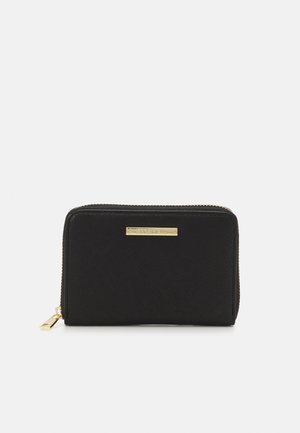 Black leather wallet with a textured surface, gold hardware, and logo plaque. Features a zip closure and compact rectangular shape.