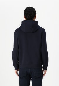Navy blue hooded sweatshirt with ribbed cuffs and hem, constructed from soft fabric. Features a kangaroo pocket at the front.