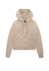 Beige zip-up hoodie with a front pocket, drawstring hood, and ribbed cuffs. Soft fabric with a subtle sheen and embroidered logo on chest.