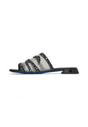 Black slide sandal with low block heel, transparent mesh upper, and black rhinestone embellishments in wave patterns.