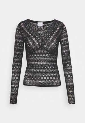Haut noir en dentelle à manches longues avec des motifs floraux et géométriques, encolure en V et silhouette ajustée.