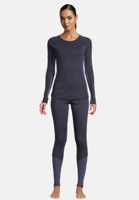 Langærmet top og leggings sæt i mørkeblåt stof med en tætsiddende pasform, kontrasterende paneldetaljer og en glat, strækbar tekstur.
