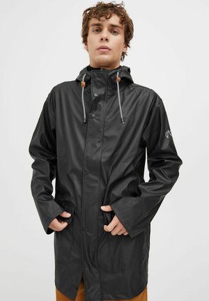 Black waterproof jacket with a hood, snap buttons, and front pockets. Features drawstrings for adjustment and a smooth, shiny texture.