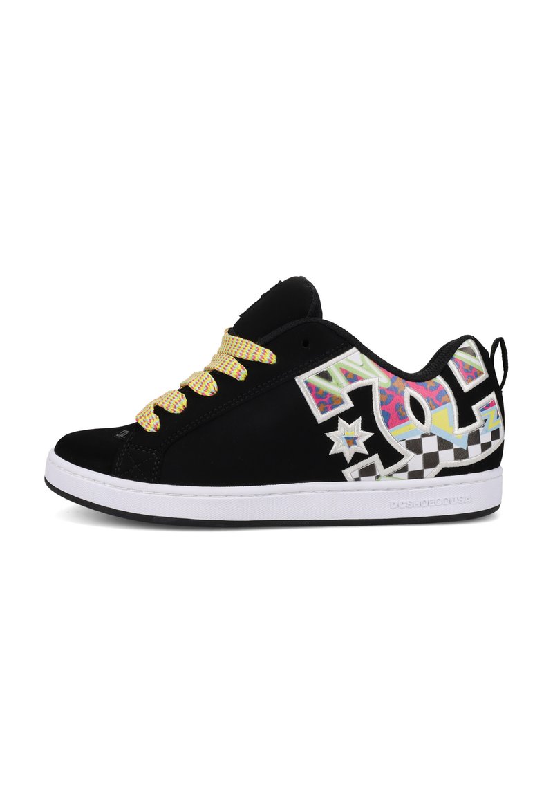 Black low-top sneaker with yellow laces, colorful graffiti-style patterns, checkerboard accents, and white sole with DC Shoes branding.
