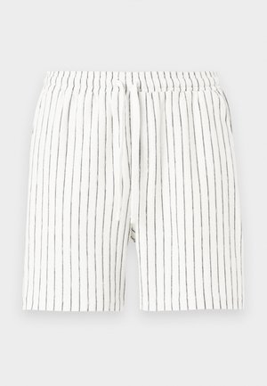 Shorts bianchi con strisce nere verticali, dotati di una cintura elastica e coulisse. Realizzati in tessuto leggero.