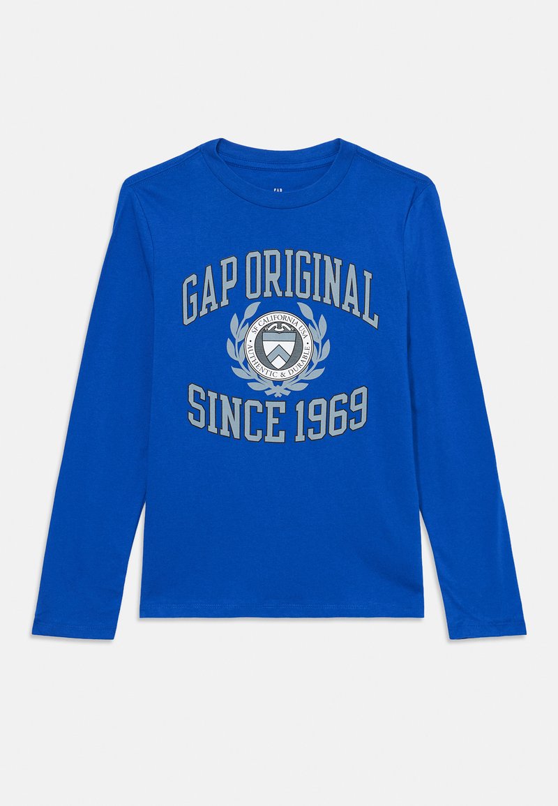 Plava dugarm rukava majica s okruglim izrezom. Sadrži natpis "GAP ORIGINAL SINCE 1969" u sivoj boji i okrugli logotip u središtu.
