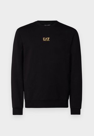 Must must have elastaanist, ümar kaelus, soonikkoes, ja vöökoht. Rinnal on kuldne "EA7" logo.