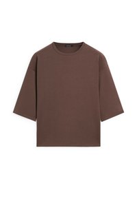 T-shirt marron oversize à manches courtes, col rond et coupe décontractée, présenté à plat sur fond blanc.