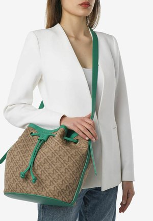 Spandbag med en lysbrun stofkrop med et gentaget logomønster, grønne læderdetaljer, justerbar snøre lukning og skulderrem.