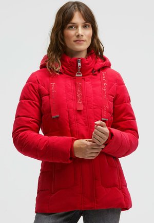 Red insulated jacket with a high collar, zip closure, and adjustable straps. Features ribbed cuffs and multiple pockets for storage.
