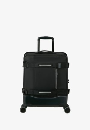 Black wheeled suitcase with telescopic handle, durable fabric, front zipper pocket, reflective accents, and smooth rolling wheels.
