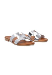 Silver metallic slide sandals with two wide straps and a cut-out design. Brown insole and flexible tan outsole. Smooth texture overall.