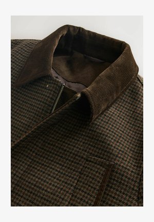 Brown checkered jacket with a corduroy collar, featuring a full zip closure and a side pocket, made from soft, textured fabric.