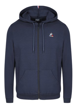 Felpa con zip di colore blu navy, realizzata in morbido cotone. Presenta una chiusura frontale con zip, due tasche e un piccolo logo sul petto.