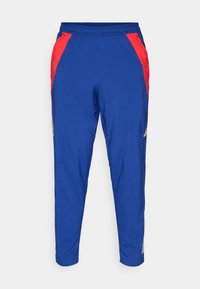 Pantalones deportivos azules con paneles laterales rojos, cinturilla elástica, piernas ajustadas y bolsillos con cremallera. Fabricados con una tela ligera y transpirable.