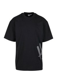 Black cotton t-shirt with short sleeves and a crew neckline, featuring a large gray graphic on the left side. Soft texture, relaxed fit.