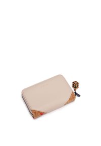Beige leather wallet with cork accents, zip closure, and decorative charm. Features a rectangular shape and smooth texture. Logo embossed on front.
